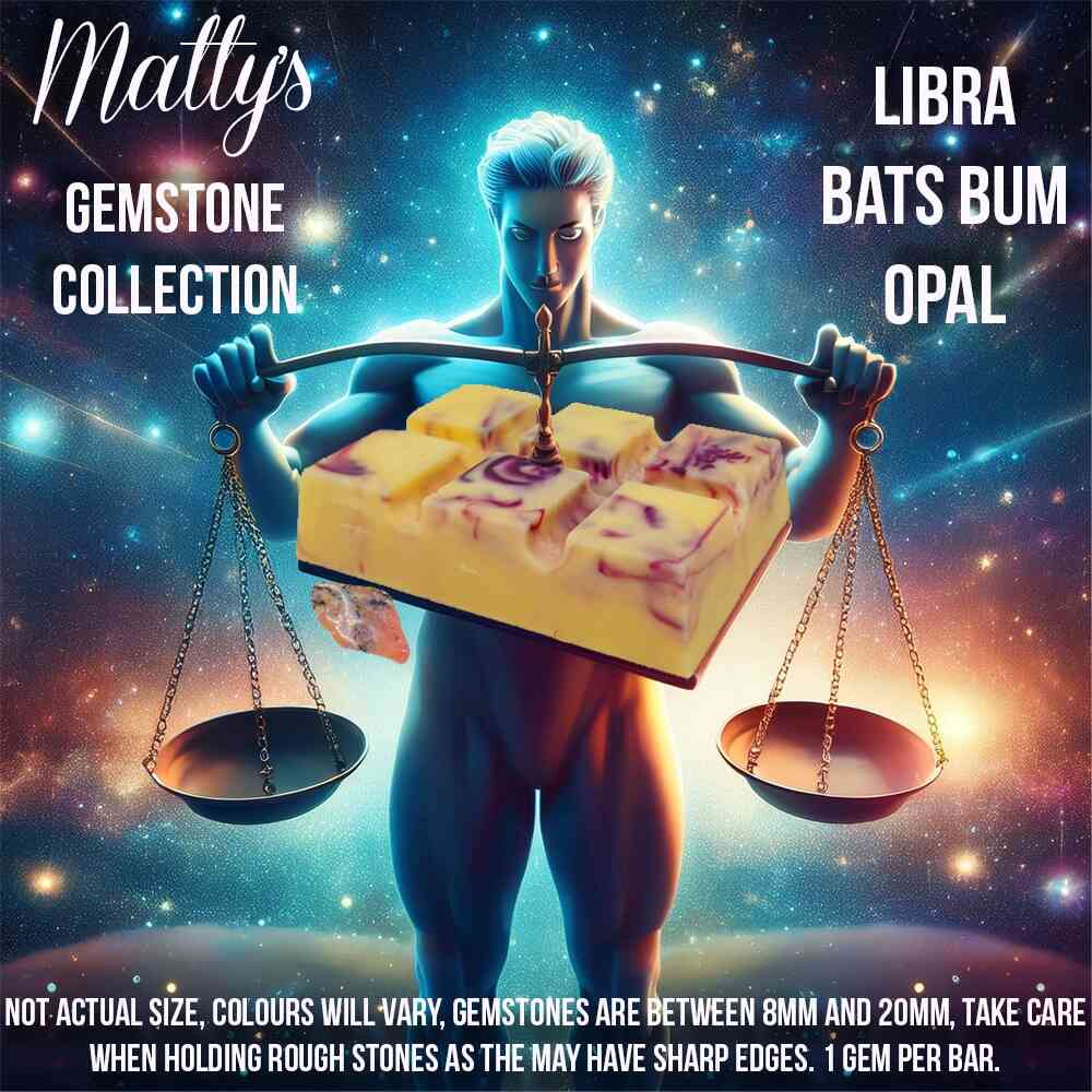 A brightly colored advertisement for "Matty's Gemstone Collection" featuring a muscular figure holding scales with gemstone soap bars. Text reads "Libra Bats Bum Opal," and includes a disclaimer about sizes and the sharp edges of rough stones.