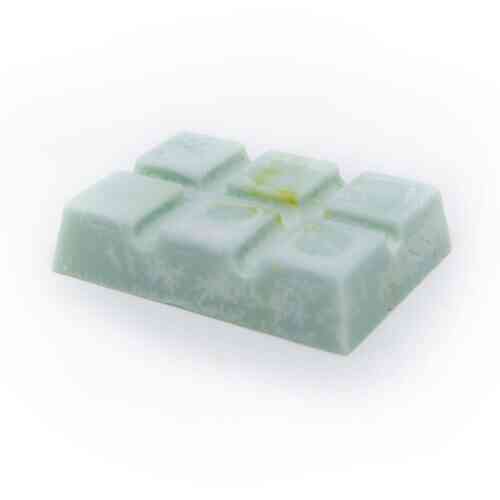 A pale green Zanzibar Snap Bar with a rectangular shape, featuring a grid-like pattern on its top surface, rests on a plain white background. This Zanzibar-inspired soap has an uneven coloration with some yellowish-green spots.